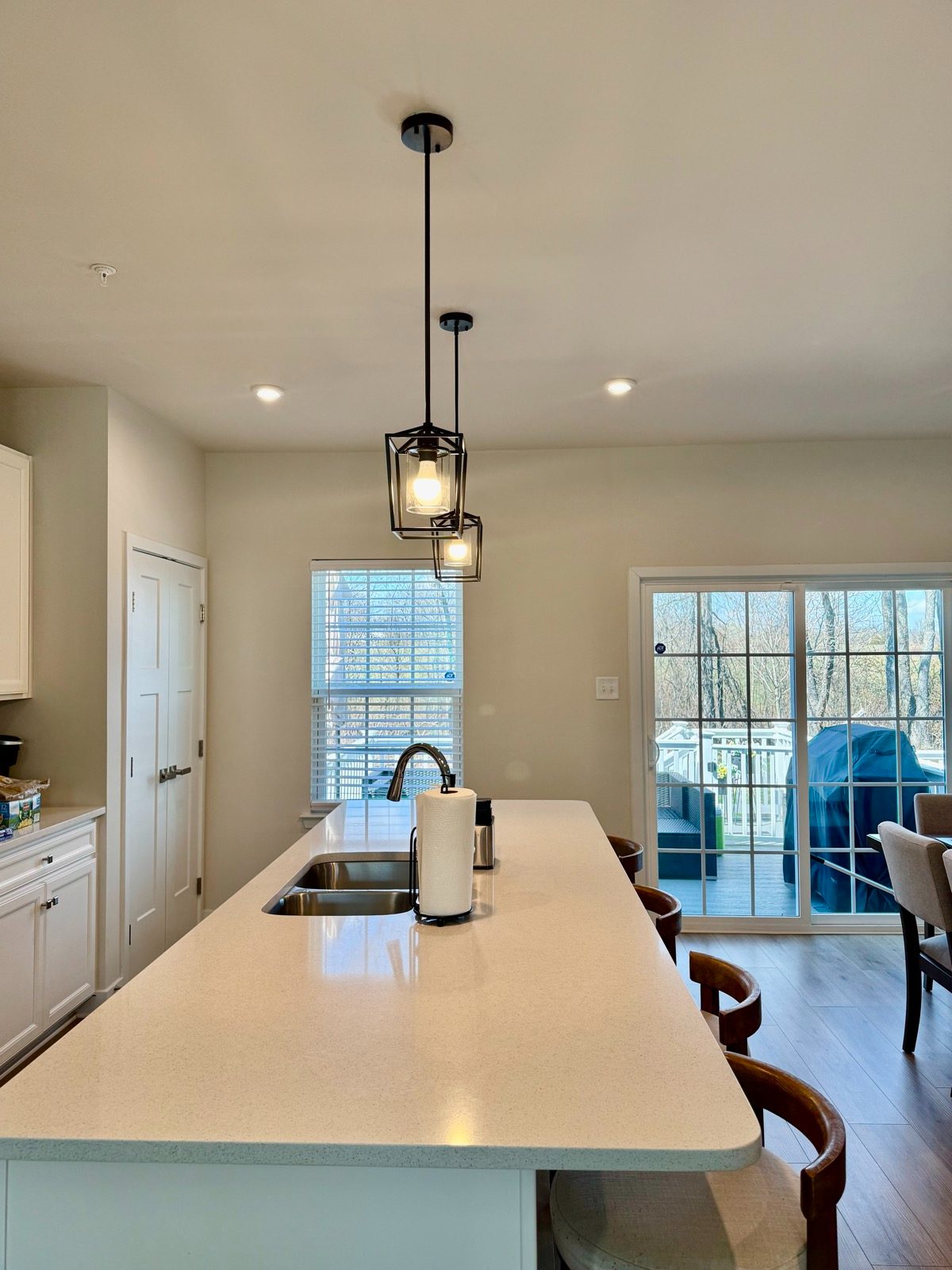 Finished kitchen with pendant lights and sliding doors by GLX Handyman