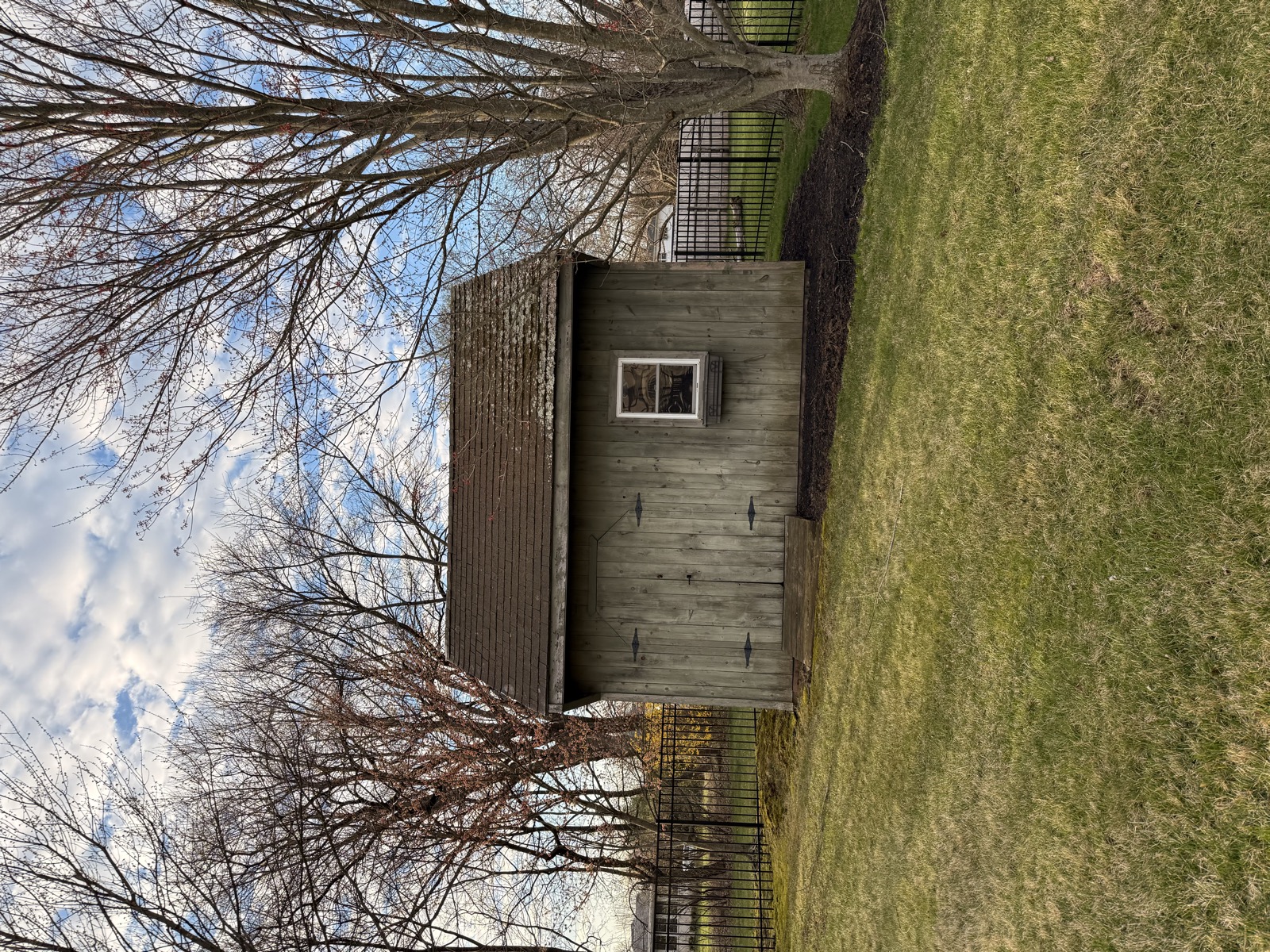 Outbuilding before — original window and siding