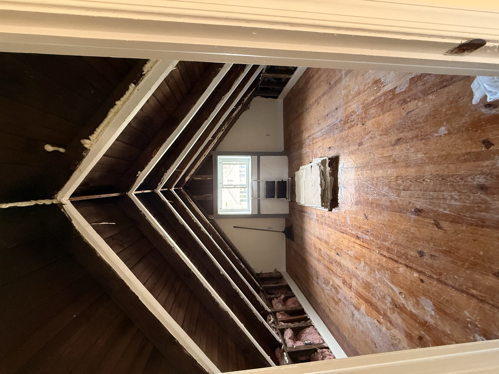 Mid-demo hallway — ceiling torn out, framing exposed by GLX Handyman